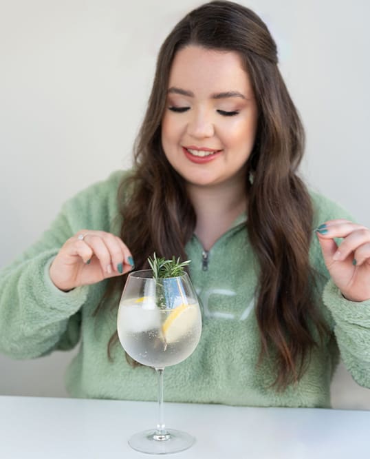 woman brand and web designer decorating a gin tonic cocktail